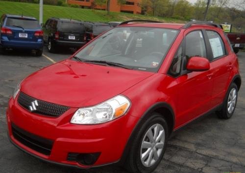 Photo of a 2010-2013 Suzuki SX-4 in Vivid Red (paint color code ZNB
